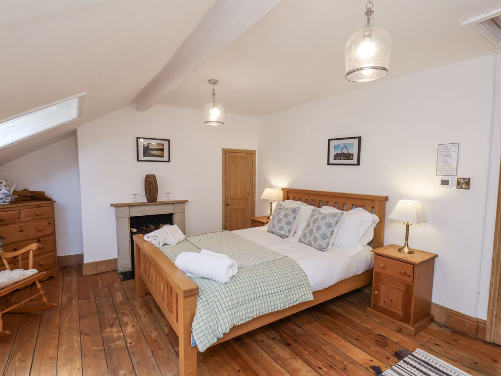 A bedroom with a bed and furniture at Charlotte House in Whitby