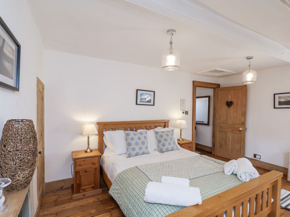 A bedroom with a bed and nightstand at Charlotte House in Whitby