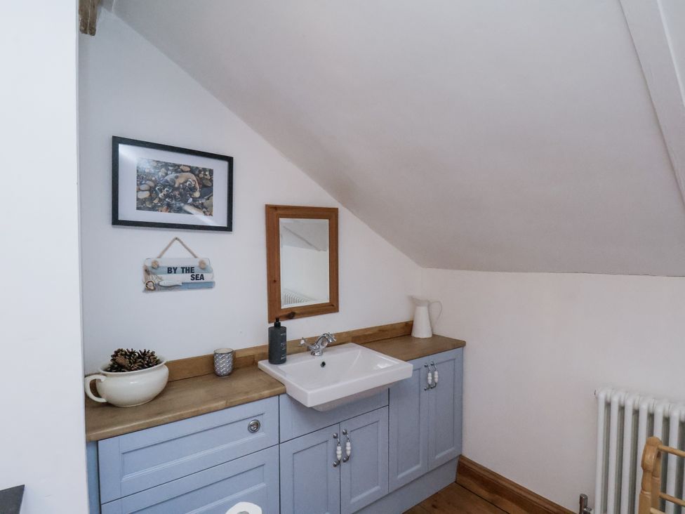 A bathroom with sink and mirror at Charlotte House in Whitby