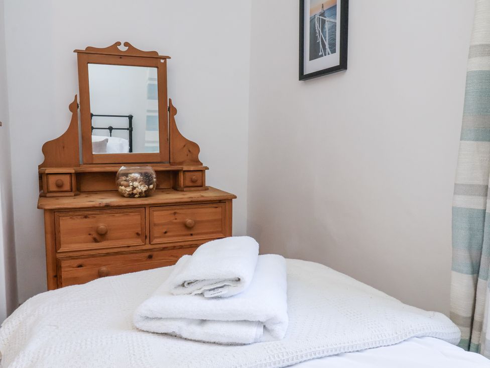 A bedroom with a mirror and dresser at Charlotte House in Whitby