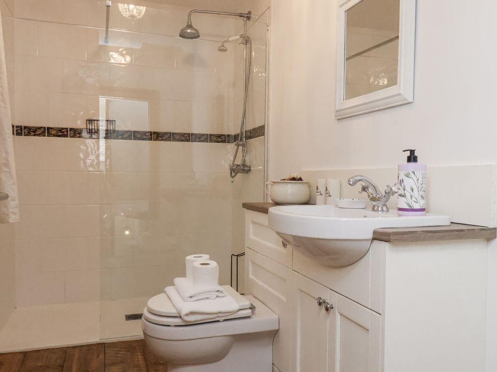 A bathroom with shower and sink at Charlotte House in Whitby