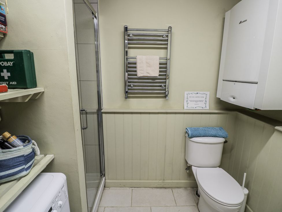 A bathroom with a toilet and shower at Dairy Cottage in Witney