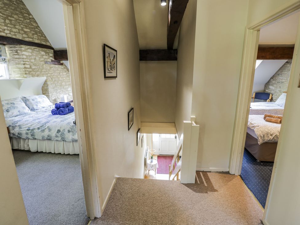 A hallway with two bedrooms visible at Dairy Cottage in Witney
