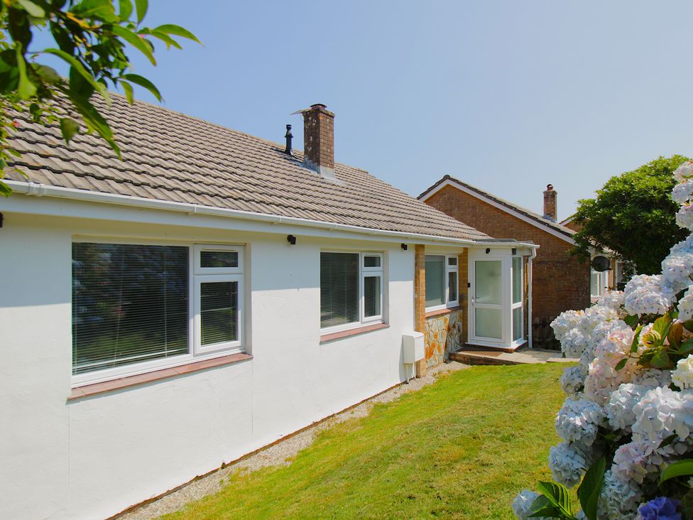 An outdoor view of a house with windows and a door at 65 Channel View Ilfracombe