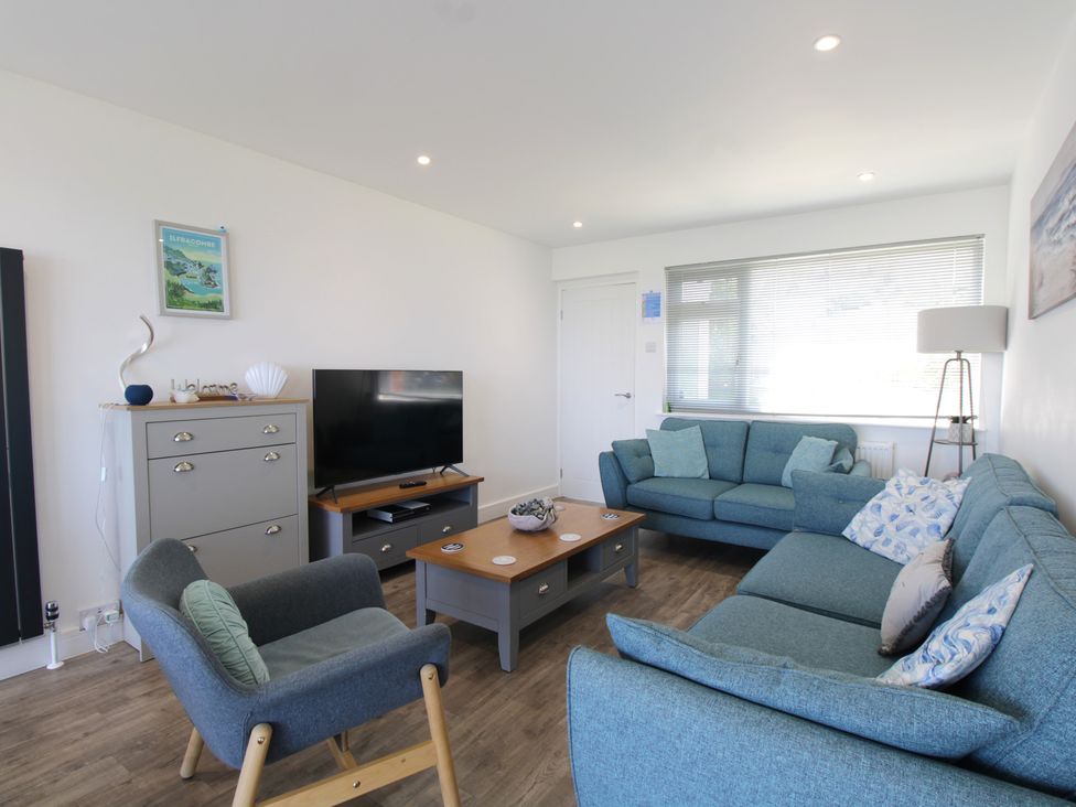 A living room with a sofa and armchair at 65 Channel View in Ilfracombe