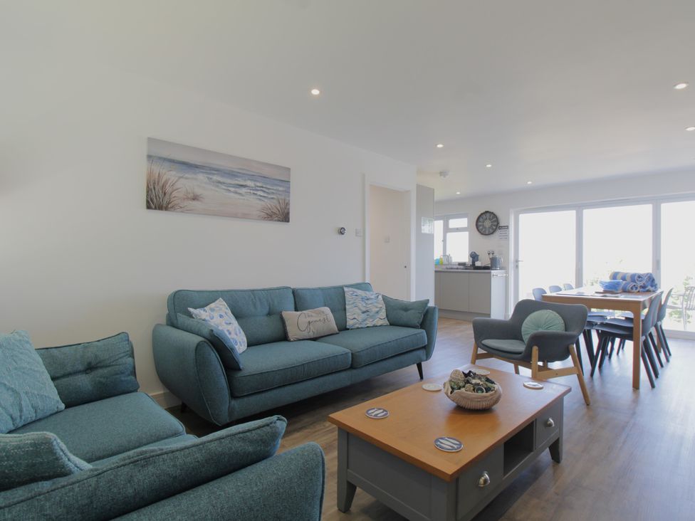 A living room with a sofa and armchair at 65 Channel View in Ilfracombe