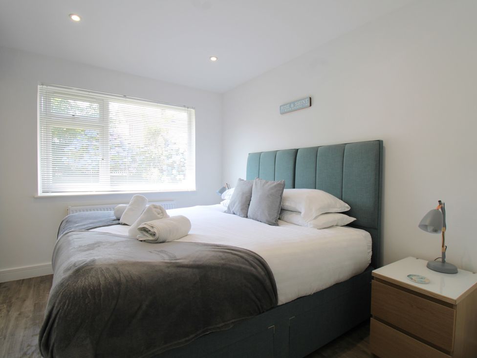 A bedroom with a bed and bedside table at 65 Channel View in Ilfracombe