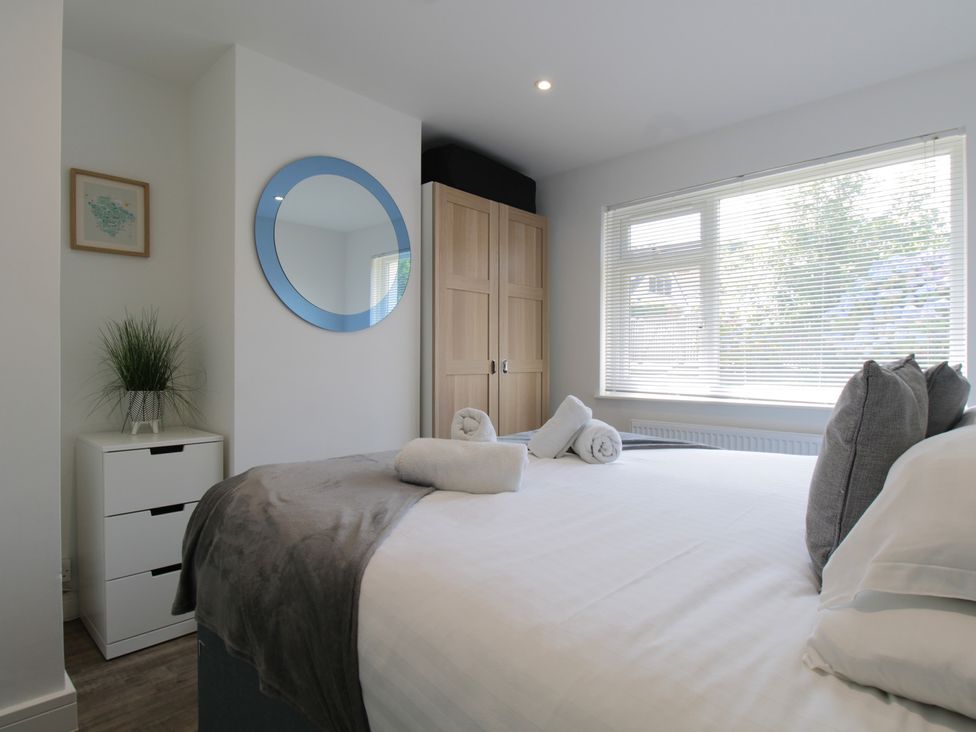 A bedroom with a bed and wardrobe at 65 Channel View Ilfracombe