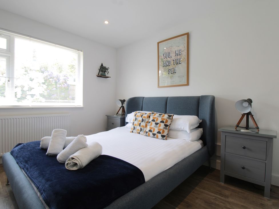 A bedroom with a bed and bedside tables at 65 Channel View in Ilfracombe