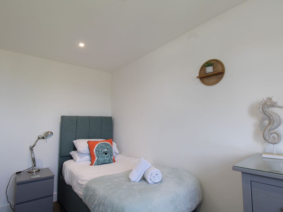 A bedroom with a single bed and side table at 65 Channel View Ilfracombe