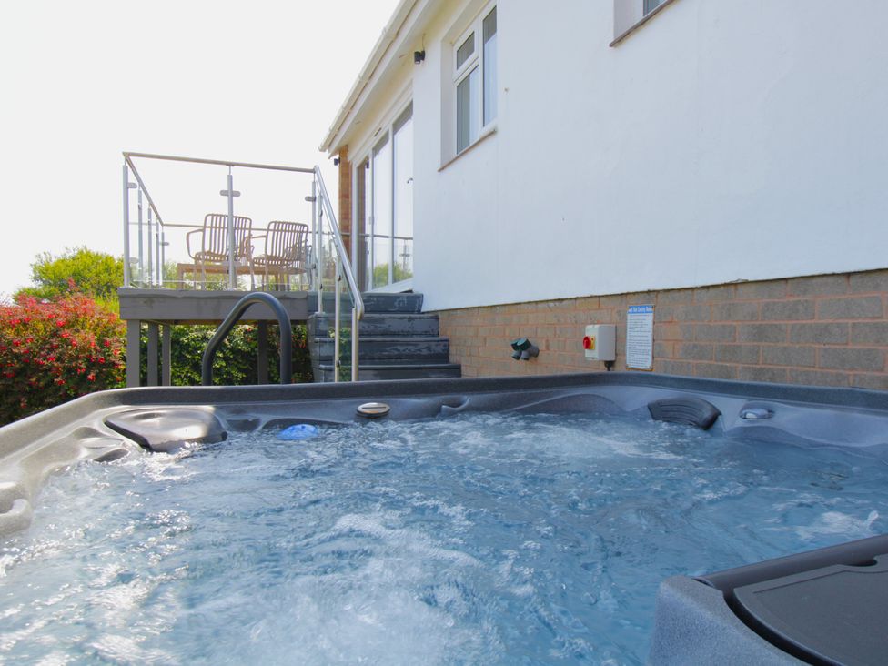 A hot tub with deck and steps at 65 Channel View Ilfracombe