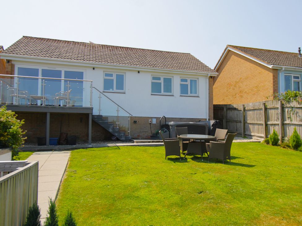 A house with a garden and outdoor seating area at 65 Channel View in Ilfracombe