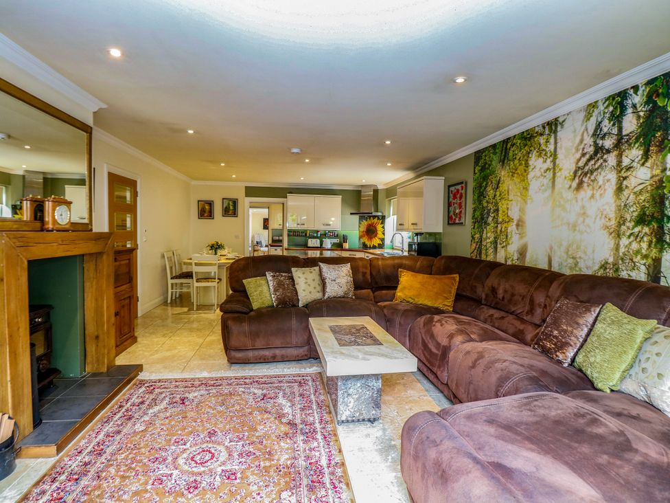 A living room with a sofa and coffee table at Birch Cottage in Brundall