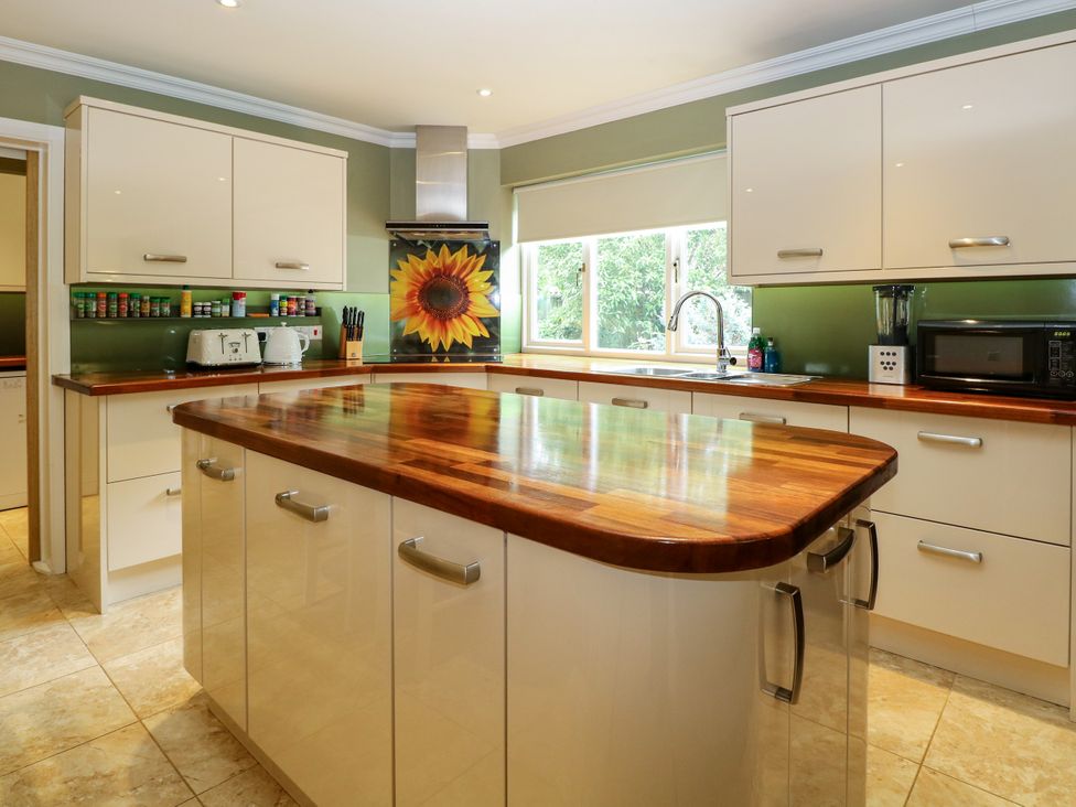 A kitchen with cabinets and appliances at Birch Cottage in Brundall