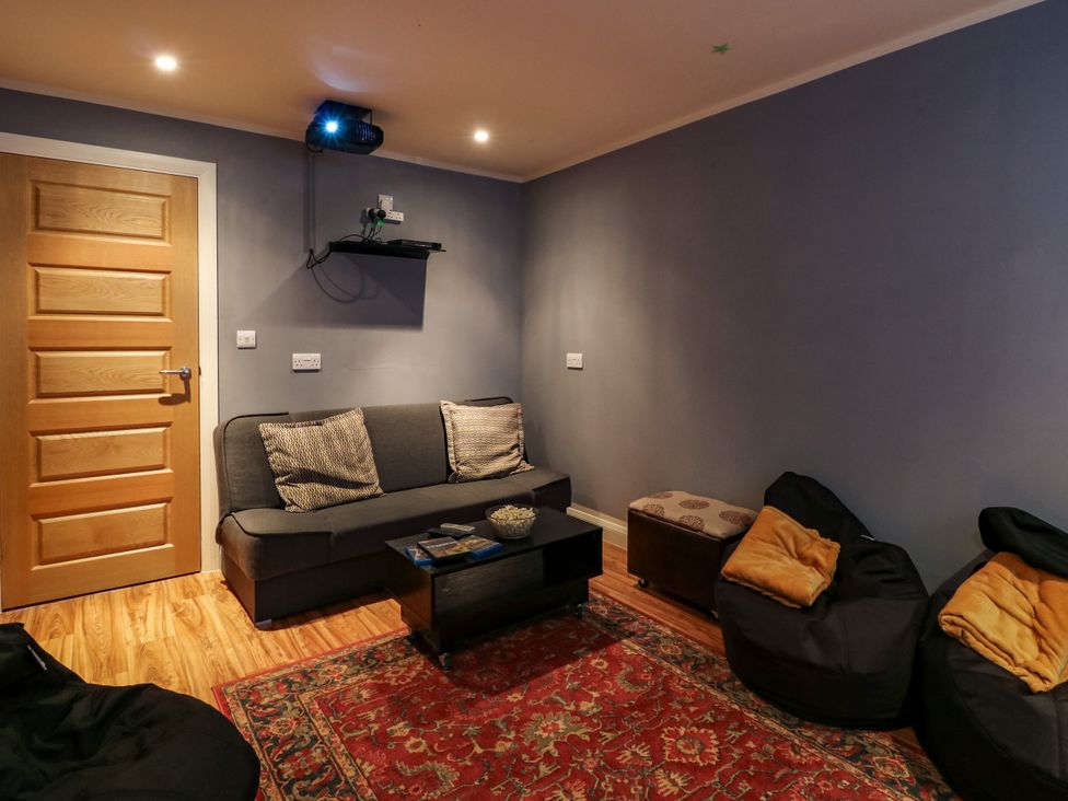 A snug with a sofa and bean bags at Birch Cottage in Brundall