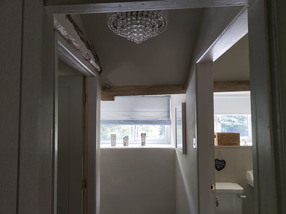 A hallway with a chandelier and a toilet at Islwyn Llanuwchllyn near Bala