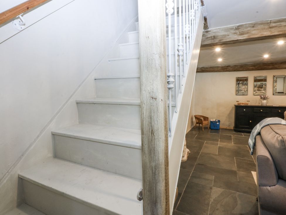 A hallway with stairs and a chest of drawers at Islwyn Llanuwchllyn near Bala