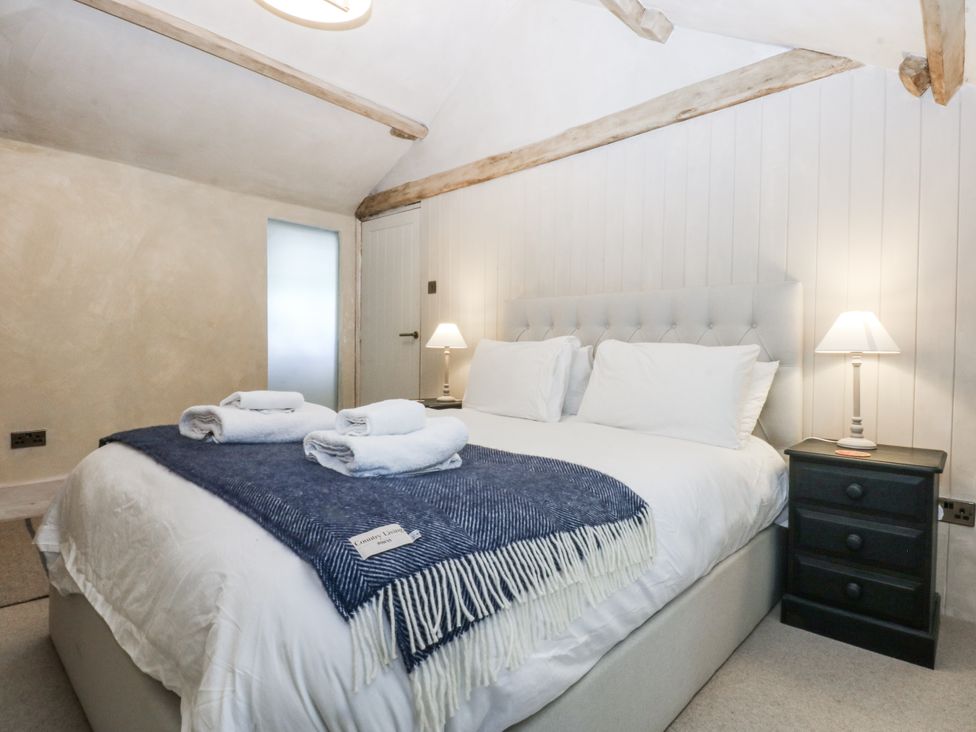 A bedroom with a double bed and bedside table at Islwyn near Bala