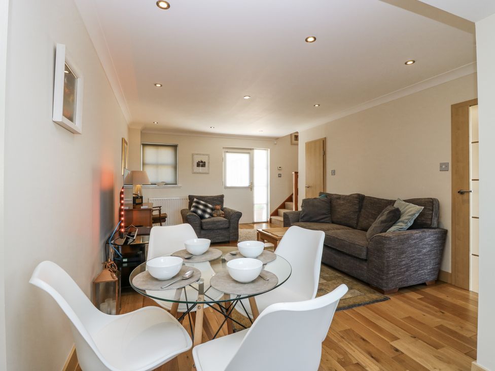 A living room with a dining table and sofa at 6A Pitlethie Steading Leuchars