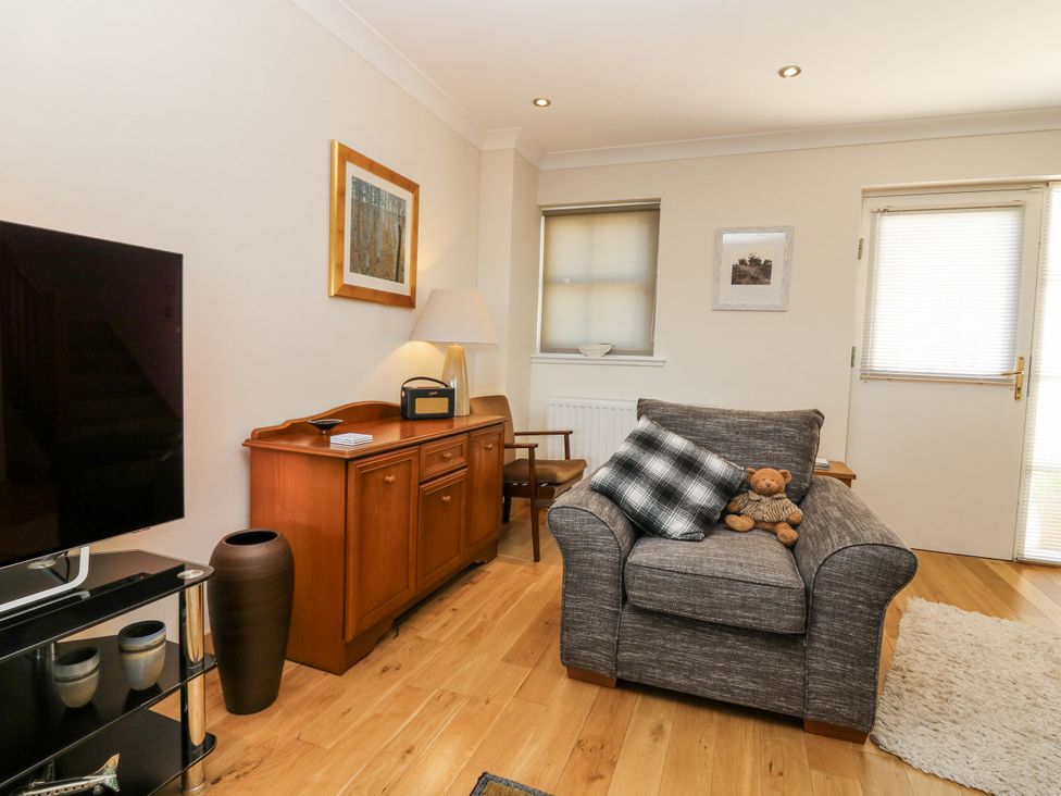 A living room with a sofa and television at 6A Pitlethie Steading in Leuchars
