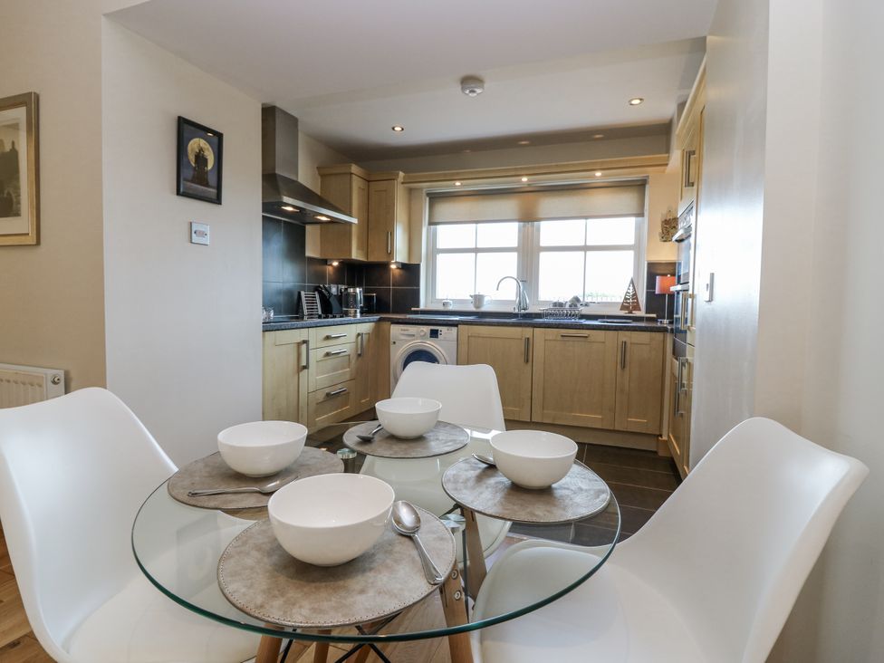A kitchen with a dining table and chairs at 6A Pitlethie Steading in Leuchars