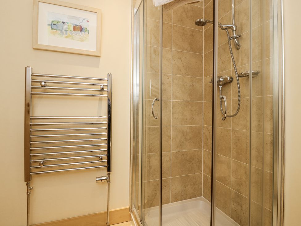 A bathroom with a shower and towel rail at 6A Pitlethie Steading Leuchars