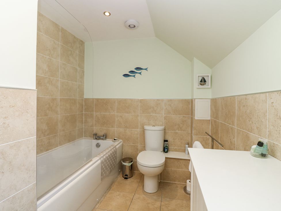 A bathroom with a bathtub and toilet at 6A Pitlethie Steading Leuchars