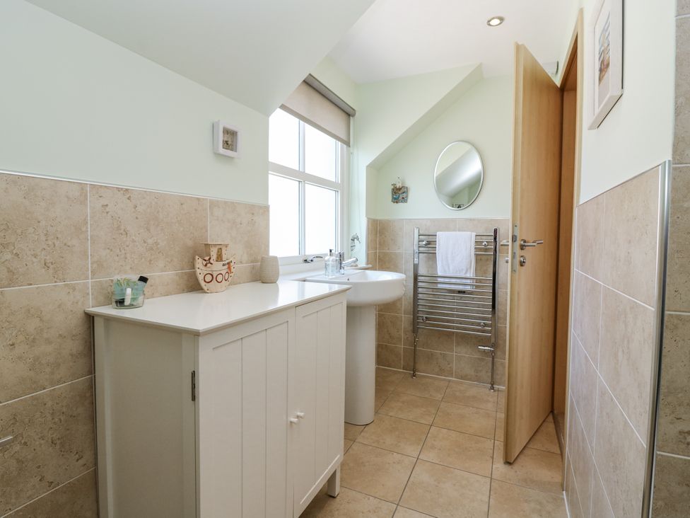 A bathroom with a sink and towel rail at 6A Pitlethie Steading Leuchars