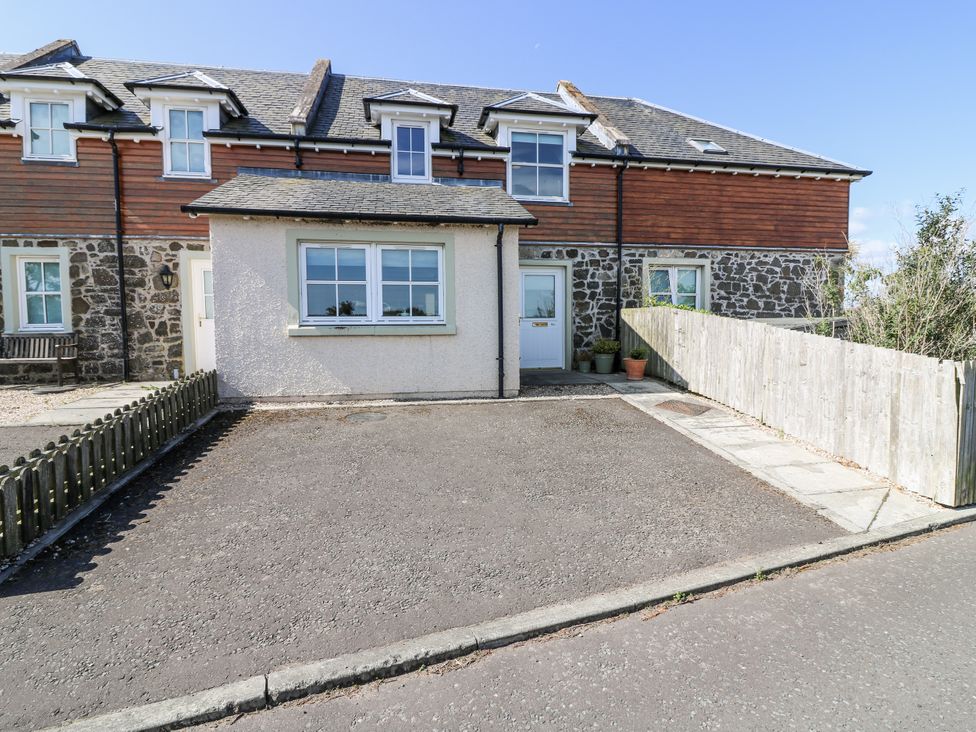 An outdoor view of a house with a driveway and fenced area at 6A Pitlethie Steading Leuchars