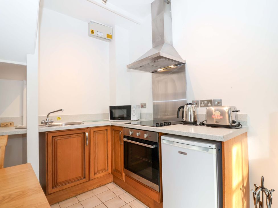 A kitchen with various appliances at Nest Cottage in St Tudy