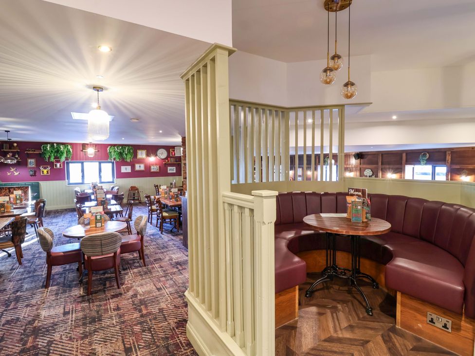 A dining room with tables and chairs at Nest Cottage, St Tudy