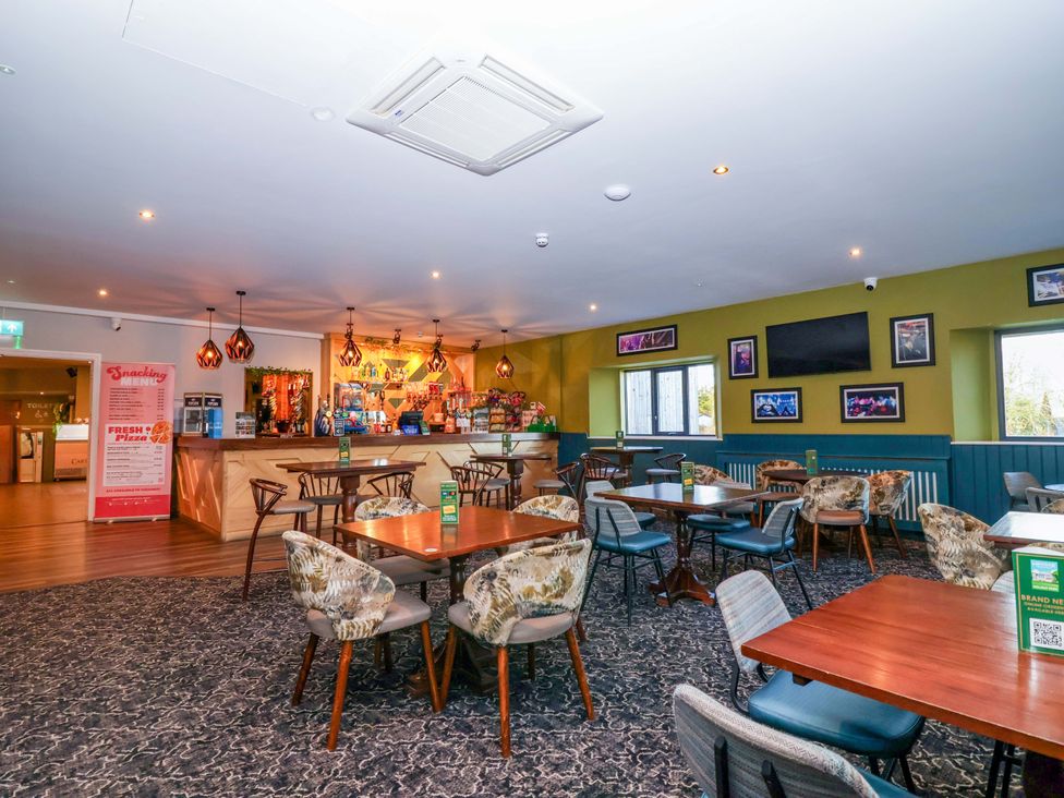 A restaurant with tables and chairs at Nest Cottage in St Tudy