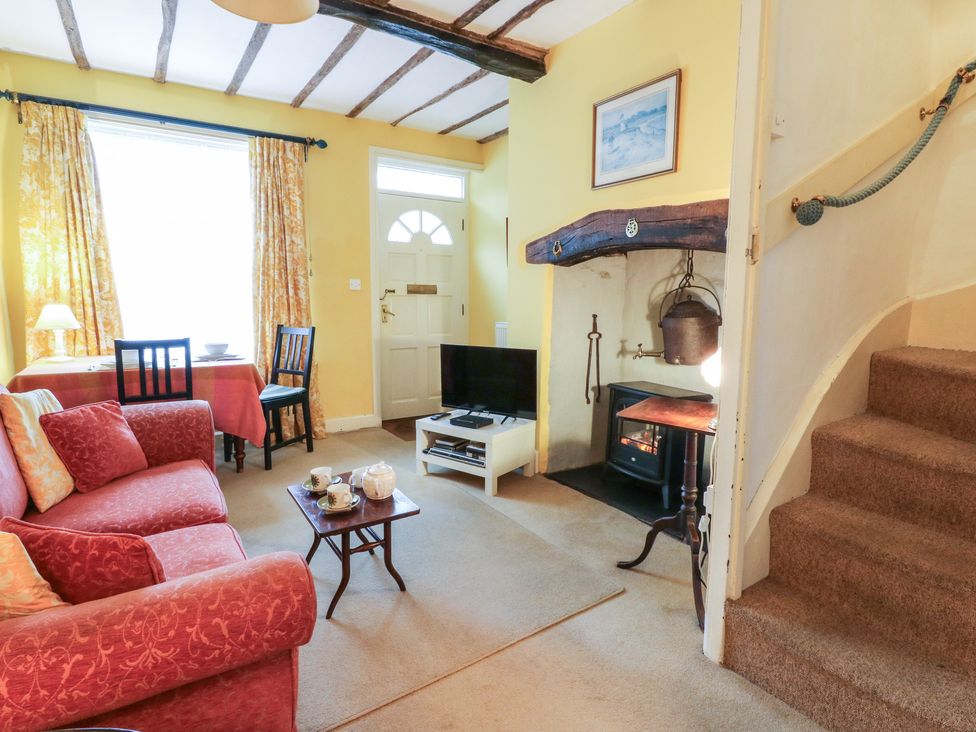 A living room with a sofa, table, and television at 6 Church Lane, Llanidloes