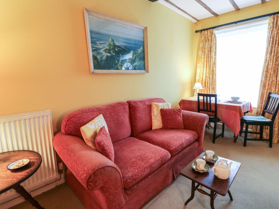 A living room with a sofa and table at 6 Church Lane in Llanidloes