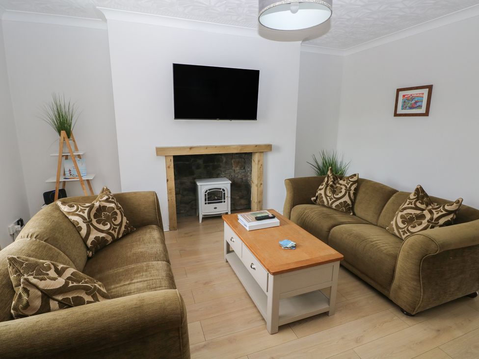 A living room with a sofa and a coffee table at Brynawel in Burry Port