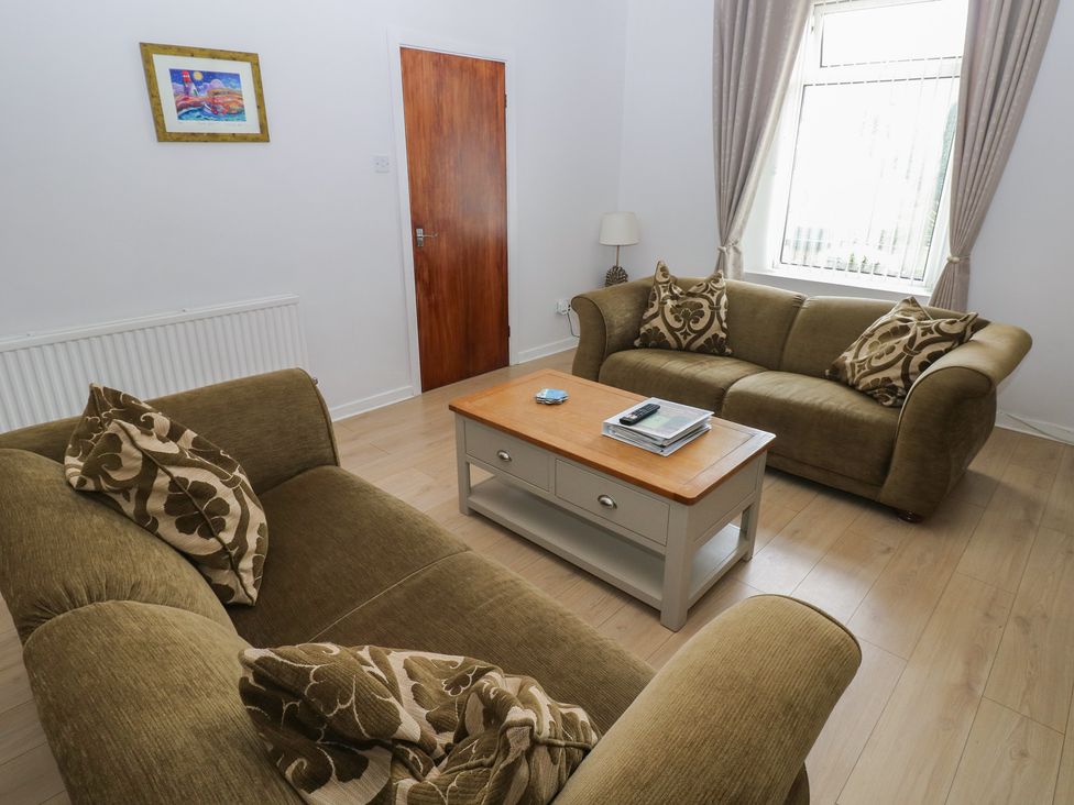 A living room with sofas and a coffee table at Brynawel in Burry Port