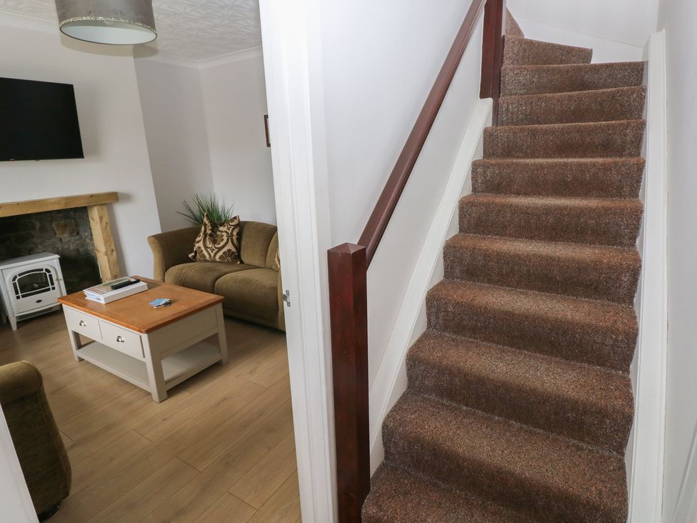 A living room with a sofa and coffee table at Brynawel in Burry Port
