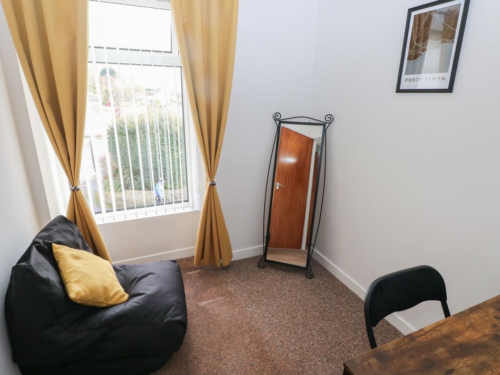 A room with a mirror and bean bag at Brynawel in Burry Port