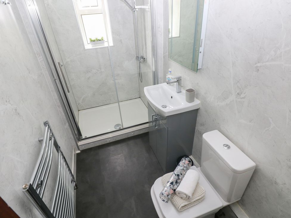 A bathroom with a shower and sink at Brynawel in Burry Port