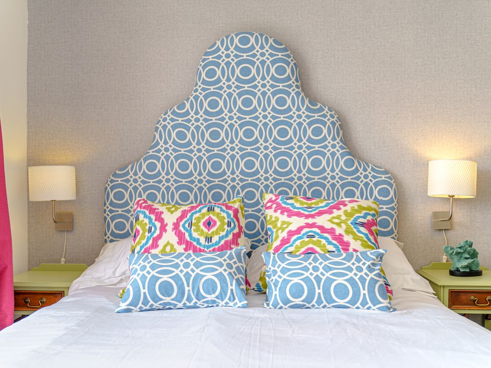 A bedroom with a bed and decorative pillows at Y Graiglwyd near Bull Bay Amlwch