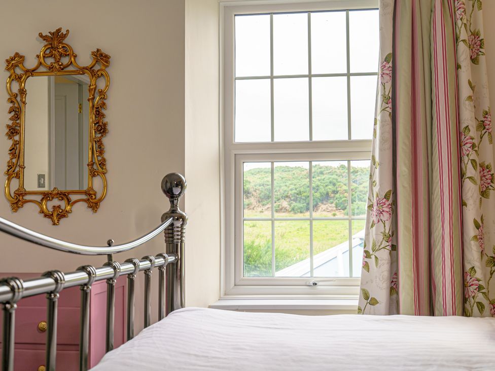 A bedroom with a bed and a window at Y Graiglwyd Bull Bay near Amlwch