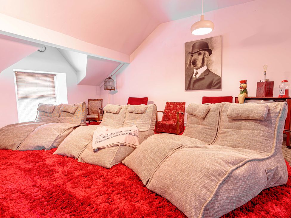 A living room with bean bags and a rug at Y Graiglwyd Bull Bay near Amlwch
