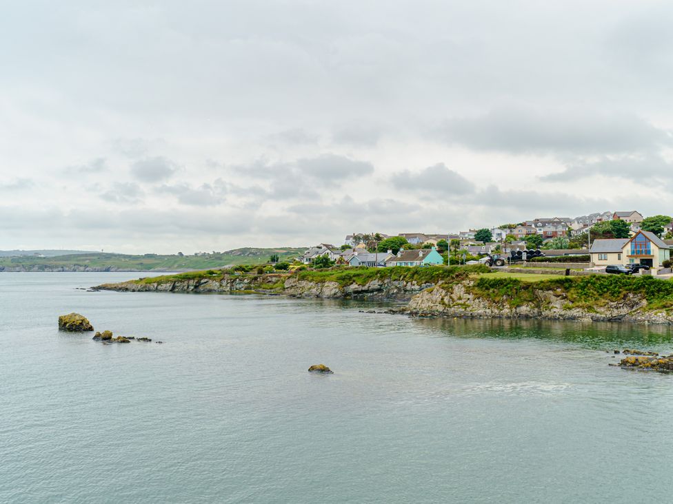 A coastal view with houses and a rocky shore at Y Graiglwyd Bull Bay near Amlwch