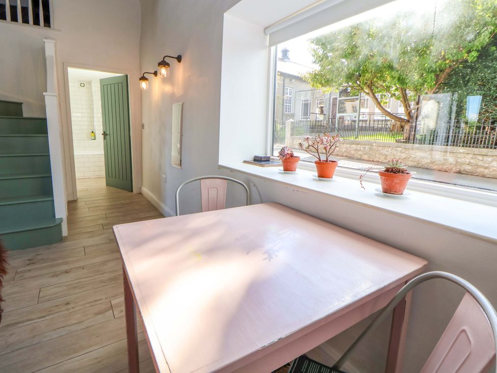 A dining room with a table and plants at Cwtch in Mold