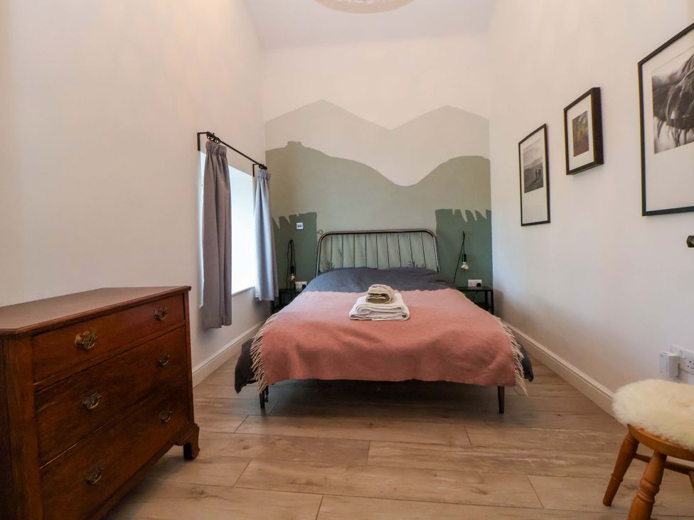 A bedroom with a bed and dresser at Cwtch in Mold