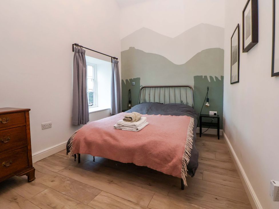 A bedroom with a bed and bedside table at Cwtch in Mold