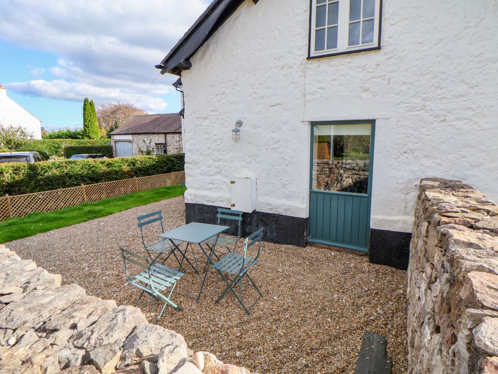An outdoor seating area with a table and chairs at Cwtch in Mold