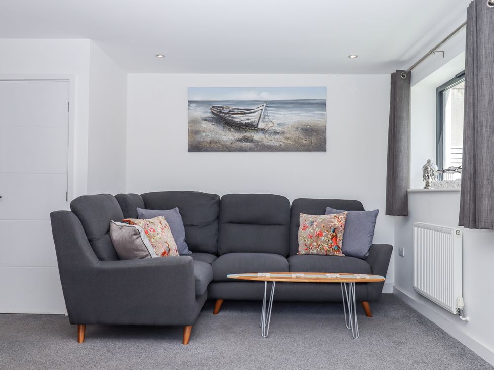 A living room with a sofa and coffee table at Driftwood in Torquay