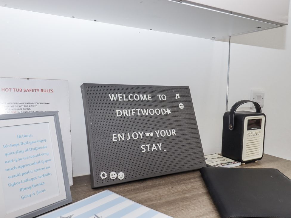 A welcome sign and radio in the reception area at Driftwood in Torquay