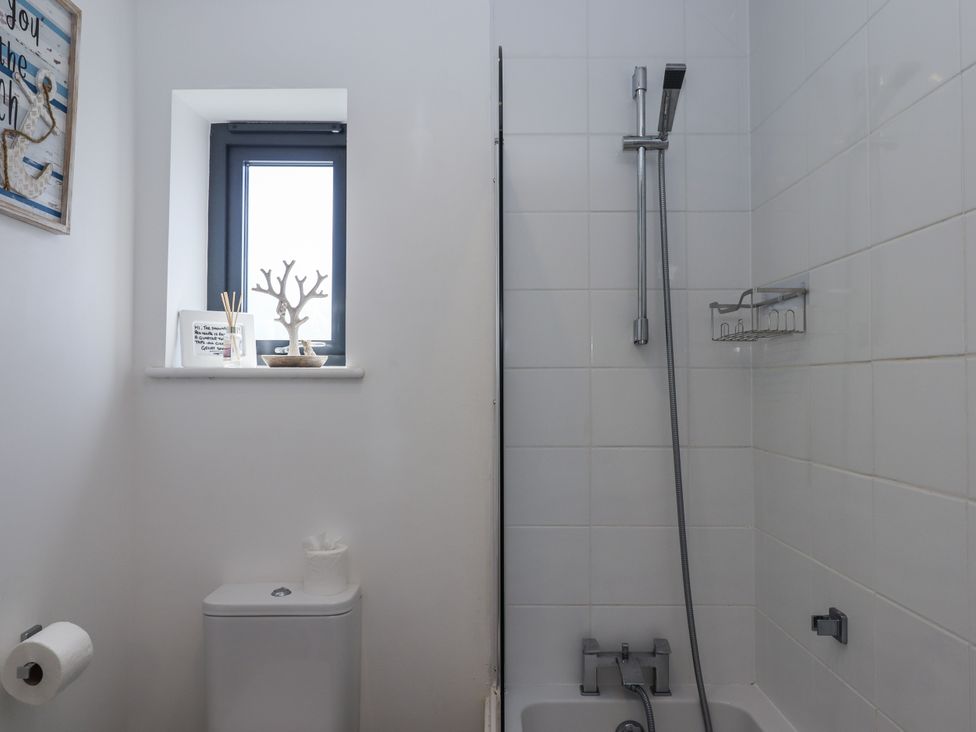 A bathroom with a shower and toilet at Driftwood in Torquay